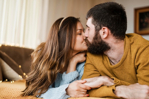 Medium shot cute couple kissing