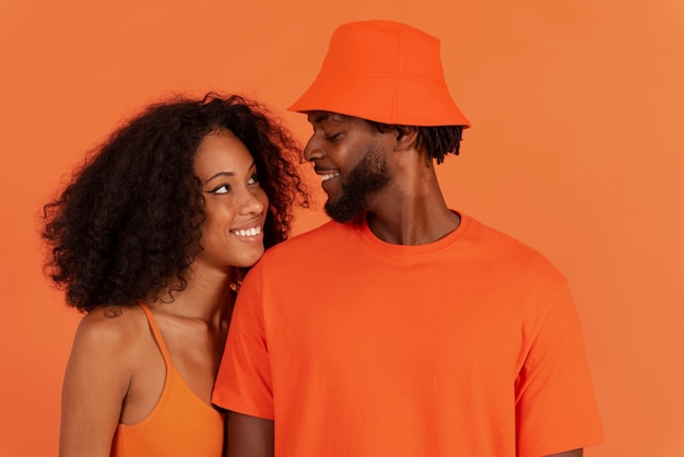 Medium shot cute couple posing together in studio