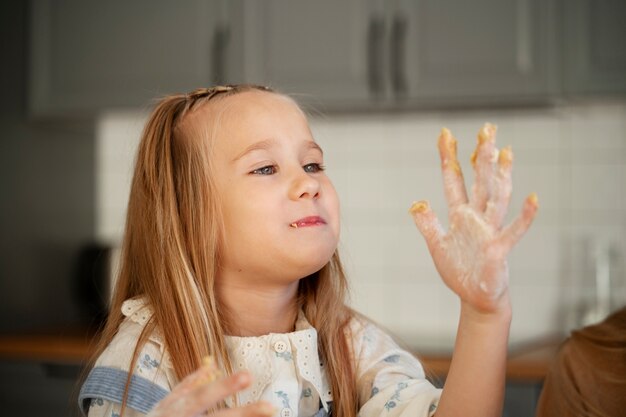 Medium shot cute girl cooking