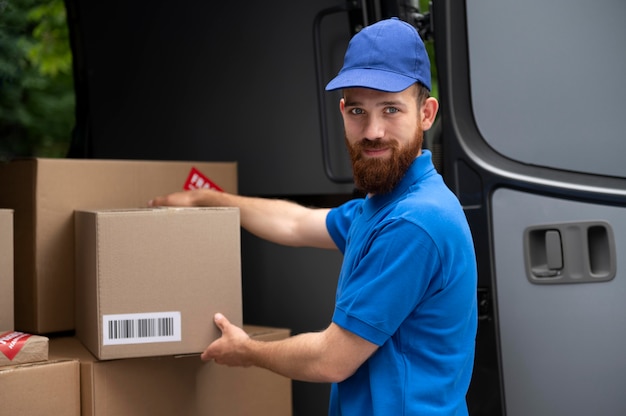 Medium shot delivery man holding box