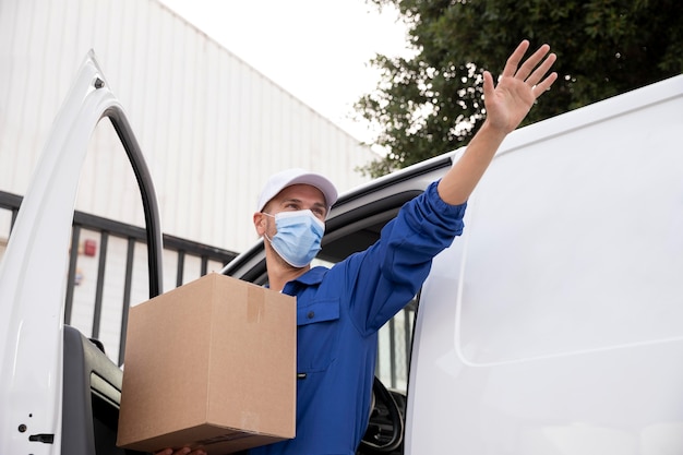 Medium shot delivery man wearing face mask