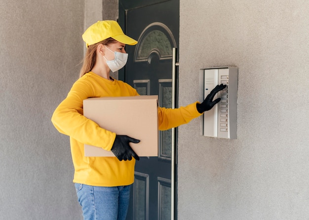 Free photo medium shot delivery woman holding box