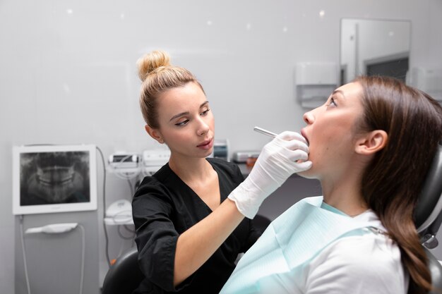 Medium shot dentist helping patient