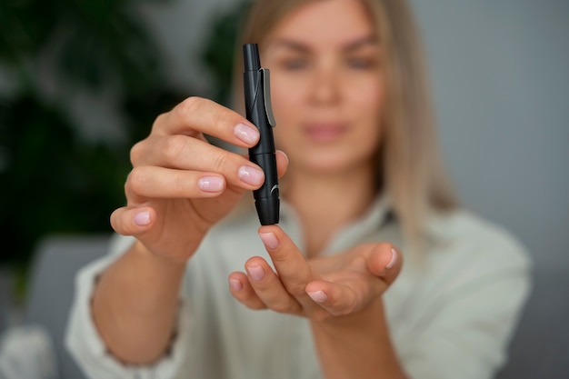 Medium shot diabetic woman checking her glucose level