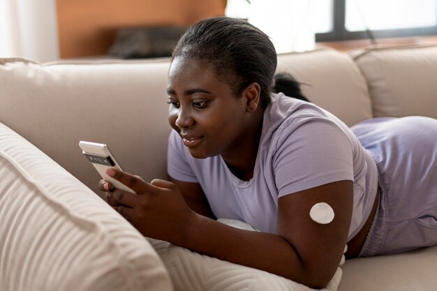 medium shot diabetic woman checking her glucose level