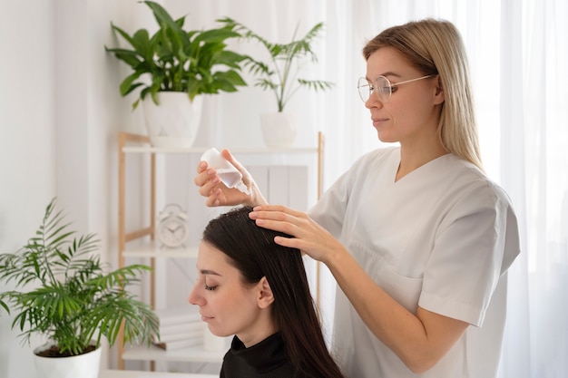 Medium shot doctor applying treatment