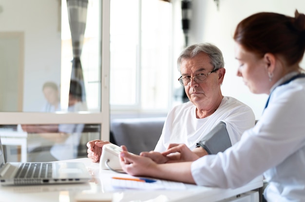 Medium shot doctor checking old patient