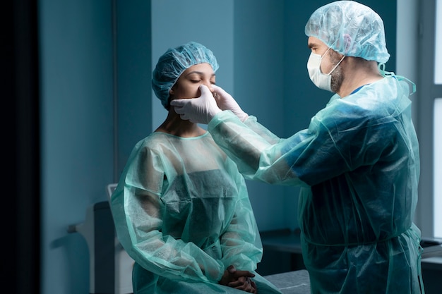 Medium shot doctor checking patient's nose