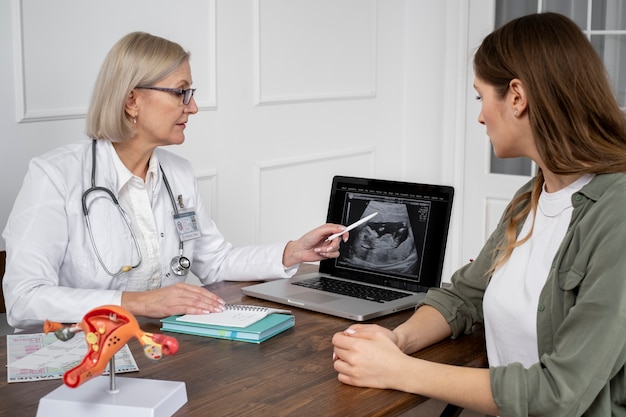 Medium shot doctor explaining ultrasound