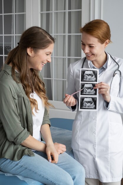 Medium shot doctor explaining ultrasounds