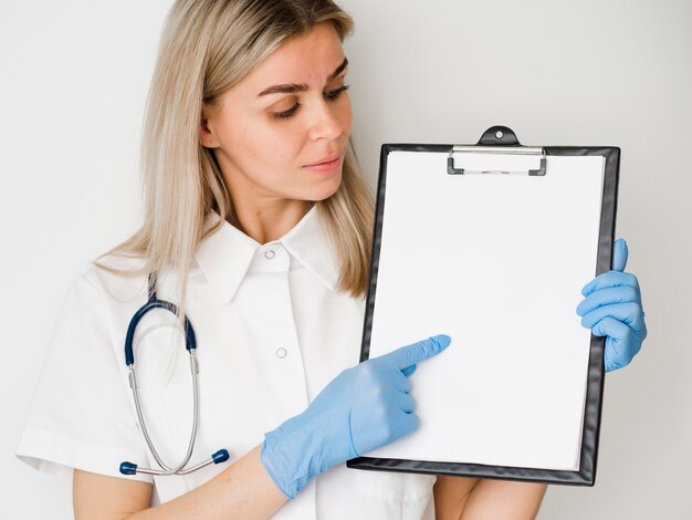 Medium shot doctor holding clipboard