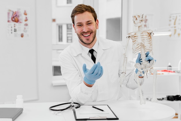 Medium shot doctor holding skeleton