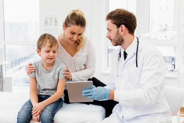 Medium shot doctor holding tablet