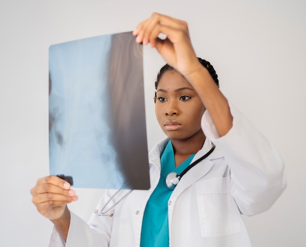 Medium shot doctor looking at radiography