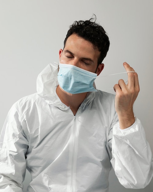 Medium shot doctor taking off mask