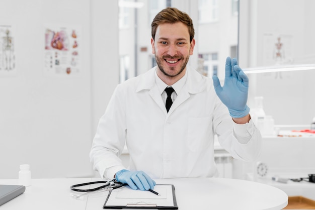 medium shot doctor wearing gloves