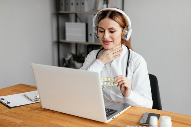 Medium shot doctor wearing headphones