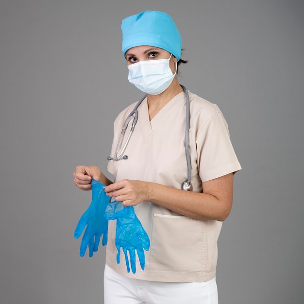 Medium shot doctor with mask and gloves