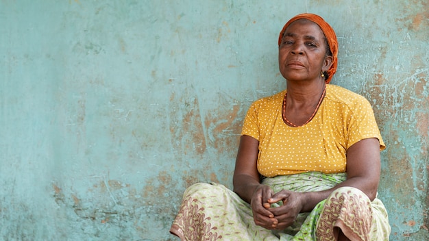 Medium shot elderly african woman exterior portrait