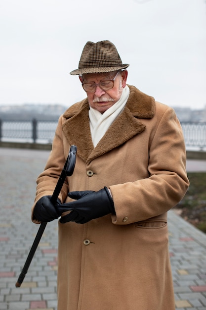 Free photo medium shot elderly man taking a stroll