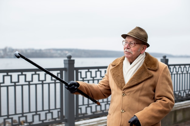 Free photo medium shot elderly man taking a stroll