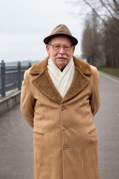 Free photo medium shot elderly man taking a stroll