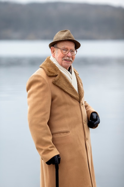 Free photo medium shot elderly man taking a stroll