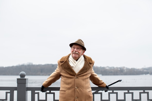 Free photo medium shot elderly man taking a stroll