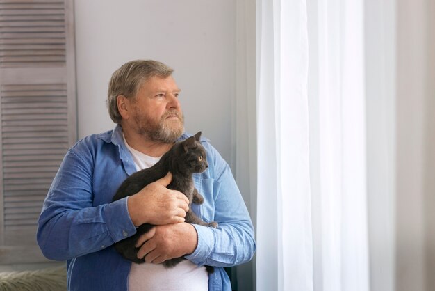 medium shot elderly man with cat