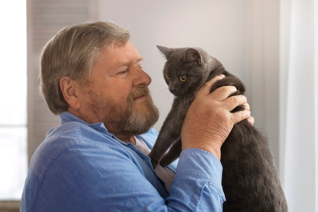 Medium shot elderly man with cat