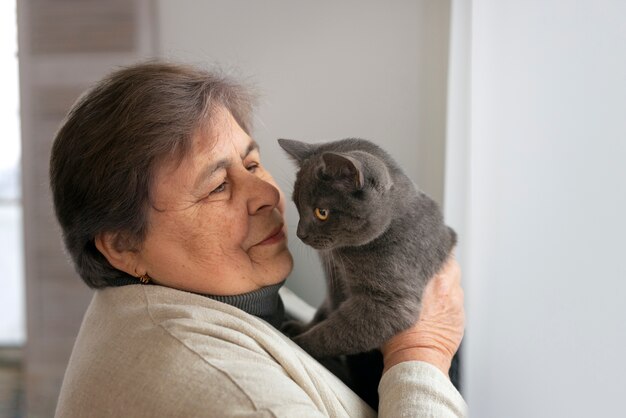 medium shot elderly woman with cat