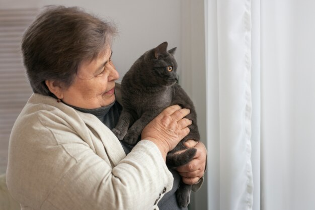 medium shot elderly woman with cat