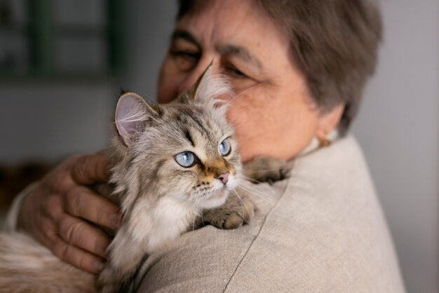 medium shot elderly woman with cat