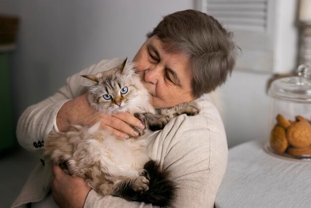 medium shot elderly woman with cat