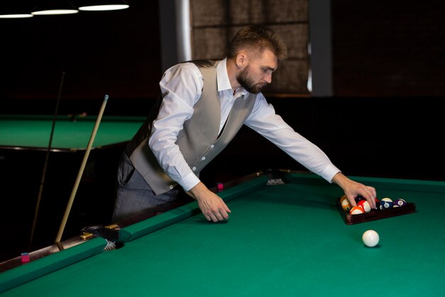 Medium shot elegant boy arranging balls 