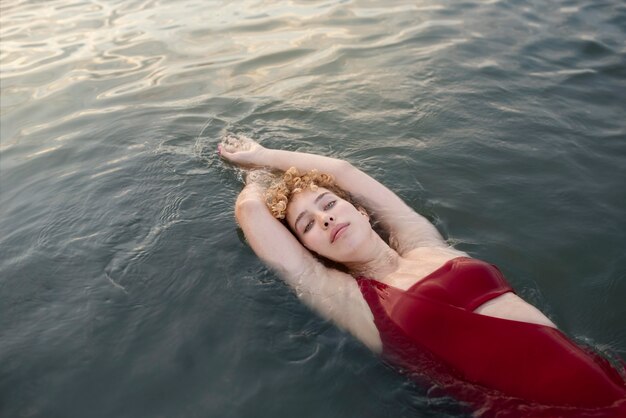 Medium shot elegant woman swimming