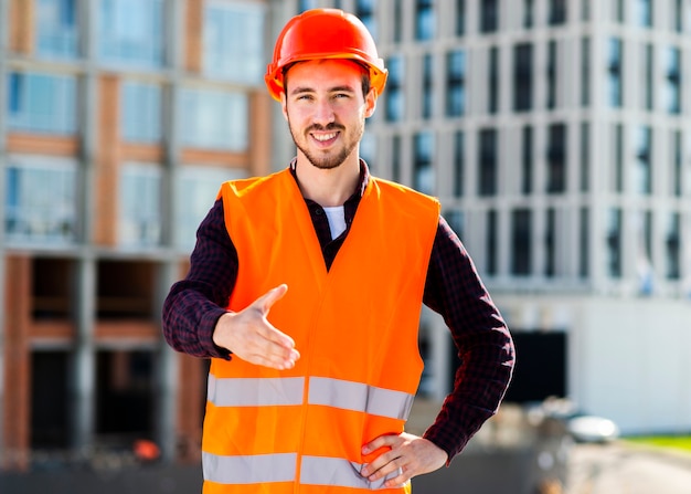 Medium shot of engineer offering handshake