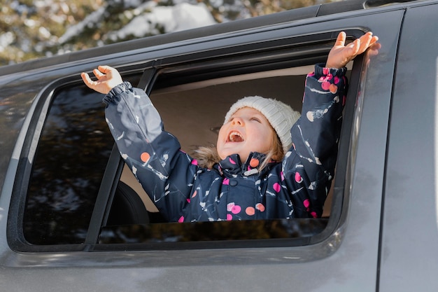 Free photo medium shot excited girl in car