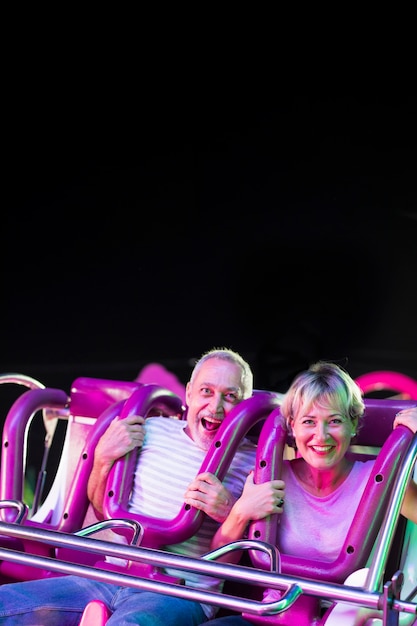 Medium shot excited people in amusement ride