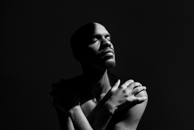 Medium shot expressive man posing with dark background