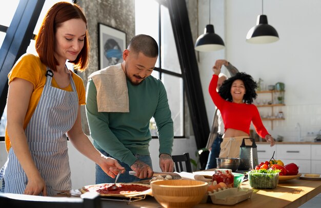 Medium shot family cooking delicious pizza