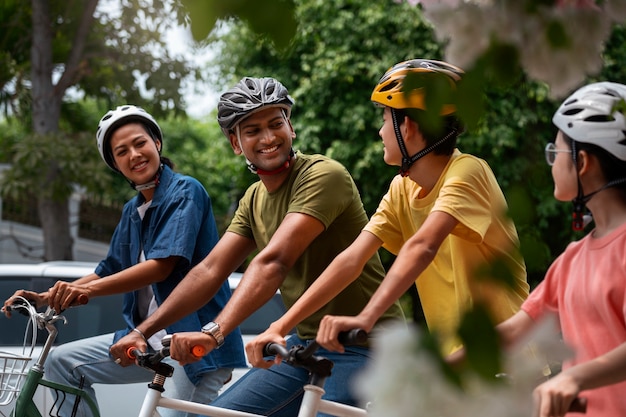 Free photo medium shot family cycling outdoors