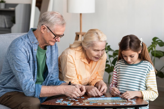 Medium shot family doing puzzle together