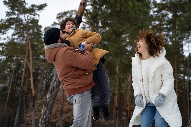 Free photo medium shot family having fun outdoors