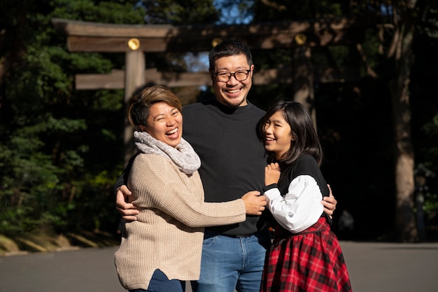 Medium shot family members holding each other