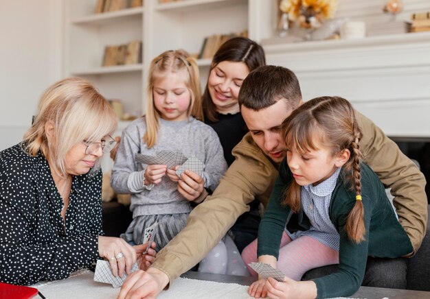 Medium shot family playing cards