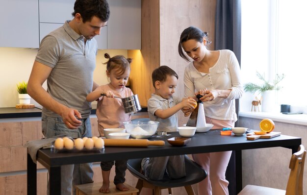 Medium shot family preparing food