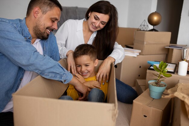 Medium shot family ready to move into a new home