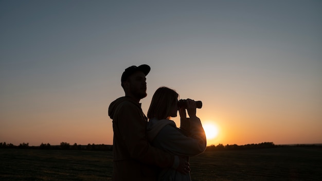 Medium shot family silhouette having fun at sunset