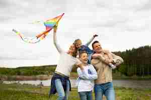 Free photo medium shot family with colorful kite